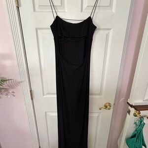 Long black medium dress with small straps and an open back